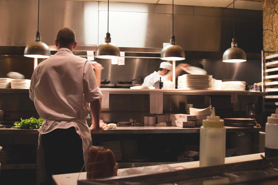 Cooks working in a busy restaurant kitchen